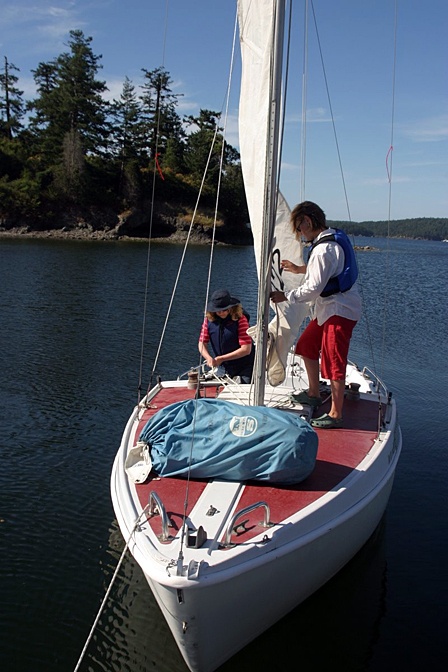 Two students learn to raise sails in the adult program.