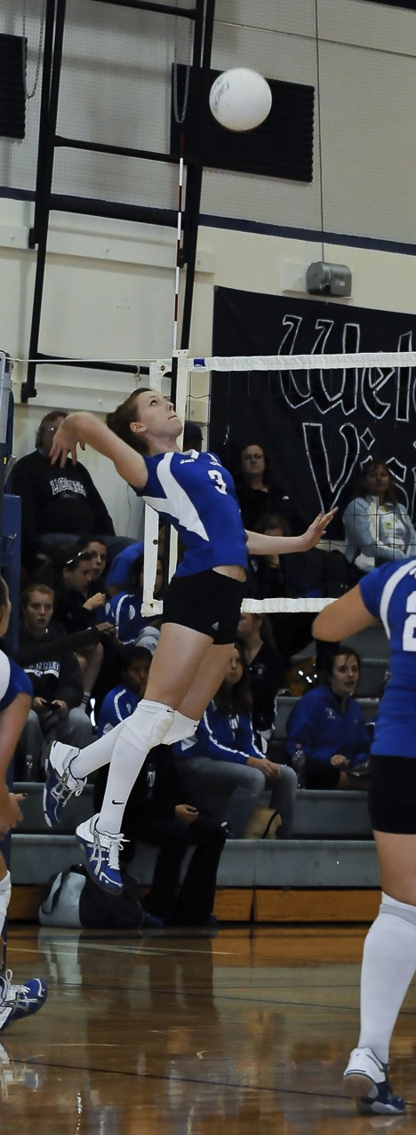 A Viking gets air under her feet before spiking the ball into La Conner's court.