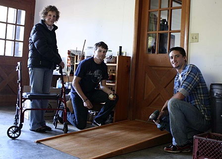 Sherry Vinson with Willie Eagan (left) and Daniel Janssen (right) as they install the ramp at her house.