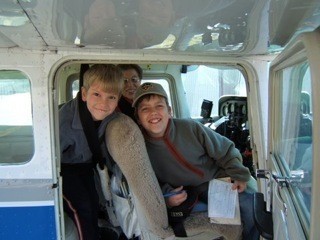 Two boys experience an airplane flight with pilot Beverly Franklet as part of the Experimental Aircraft Association 'Young Eagles Program.'