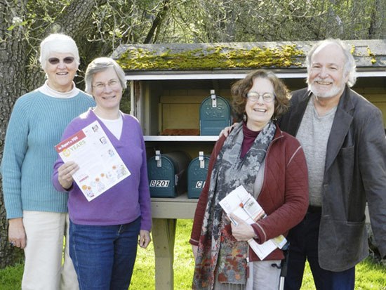 At right: Holding a preview copy of OPAL’s first “Report to the Community” is OPAL Executive Director Lisa Byers. Joining her are (left to right) Helen Bee