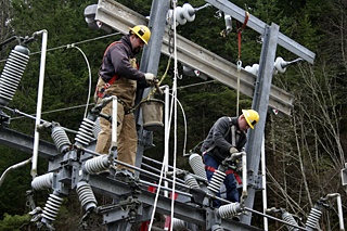 Journeyman Lineman Dan Watters and Apprentice Lineman Jeremy Price prepare the substation for the new transformer.