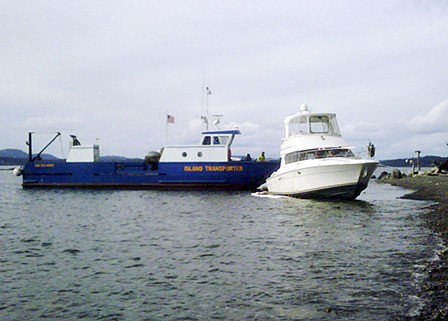 A landing craft arrives to assist the vessel.