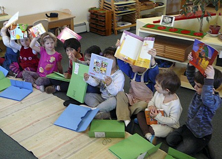 Orcas Montessori kids enjoying their new bilingual books.