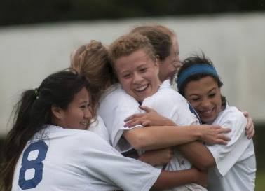 The Lady Vikings soccer team celebrating after a game in the 2014 season.