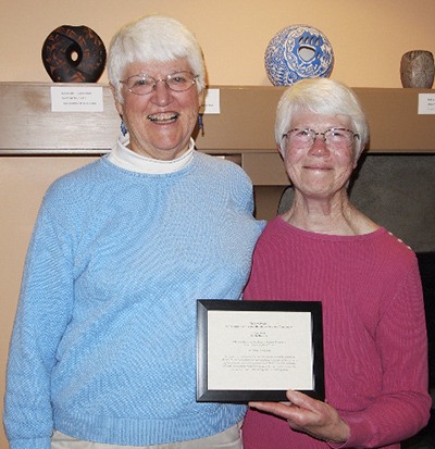 Molly Roberts is this year’s recipient of the Sky Award for volunteer service at OPAL Community Land Trust’s 23rd annual meeting. Presenting the award was Helen Bee