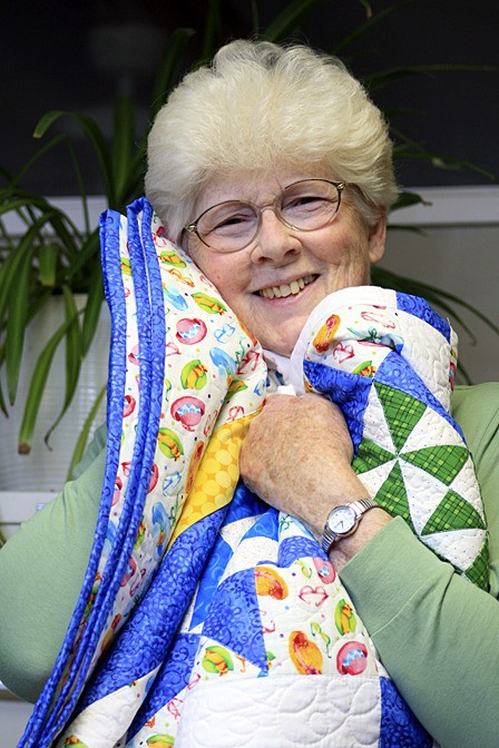 Left: Betty Marcum holds one of her quilts.