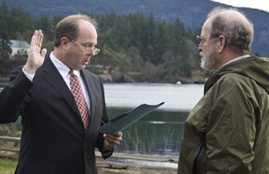 Rick Hughes being sworn in by Judge Stewart Andrew.