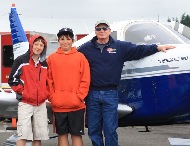 Pilot Dwight Guss with two of the aspiring Young Eagles he took for a ride earlier this summer. The Young Eagles day and the Orcas Fy-In are both hosted by the Orcas chapter of the Experimental Aircraft Association.