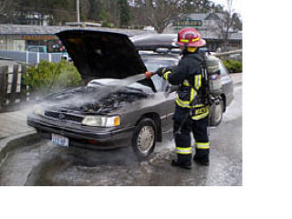 Fire Lt. Dylan Wachtel removes dry chemical used in extinguishing a car fire. Fire and Rescue responded to a call that the vehicle