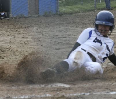 Alenna Garcia slides into home plate during the first game against Friday Harbor on April 5. The Lady Vikings played a double header.