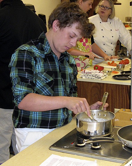 Nile Reed preparing his grand prize winning recipe of “Maple Vanilla Panna Cotta with Blackberry Sauce” in the first OISD Student Chef Competition which occurred in April of this year.