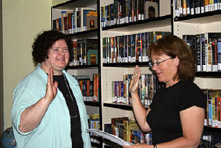 Janet Brownell (r) swears in Barbara Kline as Orcas Island School District Superintendent (l).