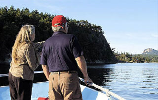 Leslie Seaman points out “Turtle Knob” to Cruise guest Ron Glassert during the museum’s benefit Cruise into History on September 13.