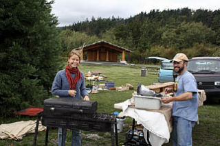 Rob Kirby and Heidi Bruce of Local Goods gather up their wares at the last outdoor Farmers’ Market for the season on a blustery Oct. 4.