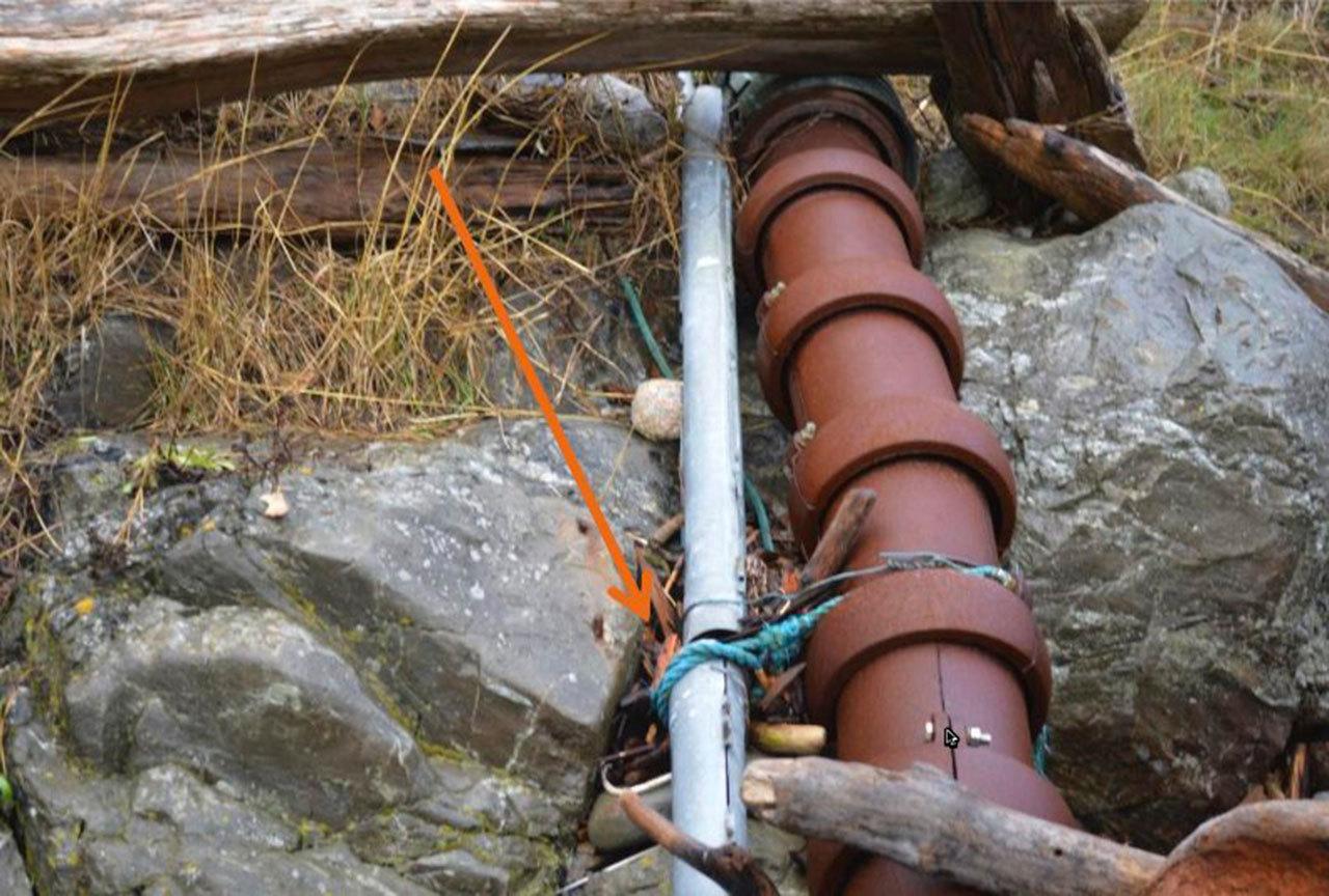 Contributed photo/Public records request CenturyLink’s fiber cable is connected to OPALCO’s power cable with rope and wire near OPALCO’s Pear Point substation.