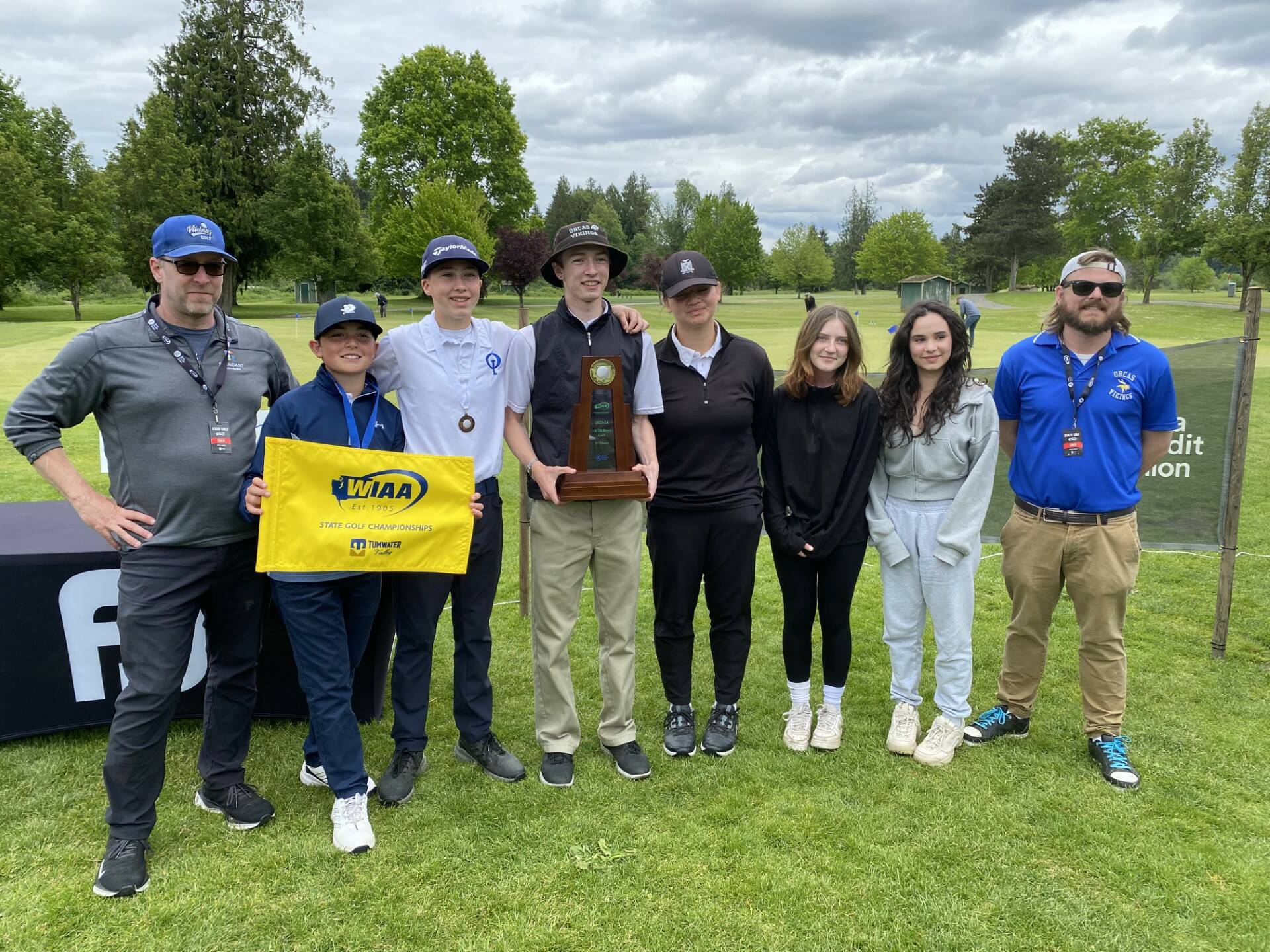 From left to right: Coach Chris Sutton, Joseph Anderson, Joshua Spinner, Sam Sutton, Lili Malo, Chloe Anderson-Cleveland, Vera Sasan, and coach Ryan Kennedy.
