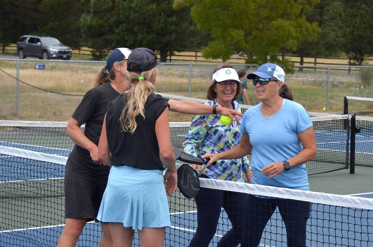 Player camaraderie: Jenny Shrum and Carolyn Storey with Patty Miller and Lisa Robson at the net.