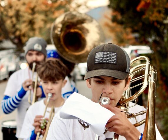 <p>Corey Wiscomb photo.</p>
                                <p>Music Teacher Darren Dix (back left) lead the Marching Band through the streets of Eastsound and all the way to the stage on the Village Green where they performed for the Homecoming community festivities.</p>