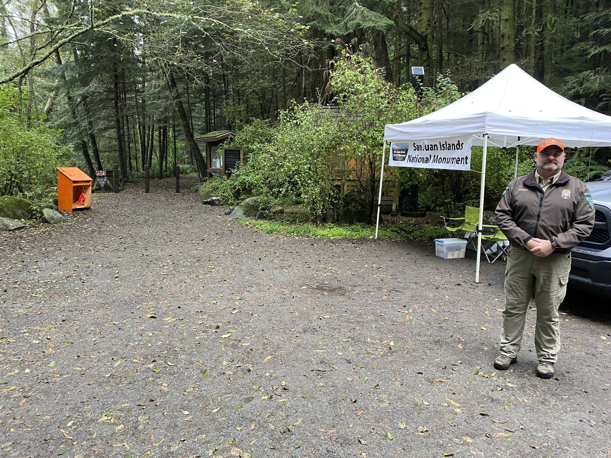 WDFW district biologist Kurt Licence and BLM staff at the kiosk near Watmough Bay on southern Lopez Island.