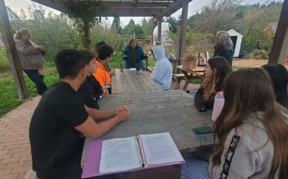 <em>Students and teacher Anna Vedder learn about composting and the impact it can have. </em>