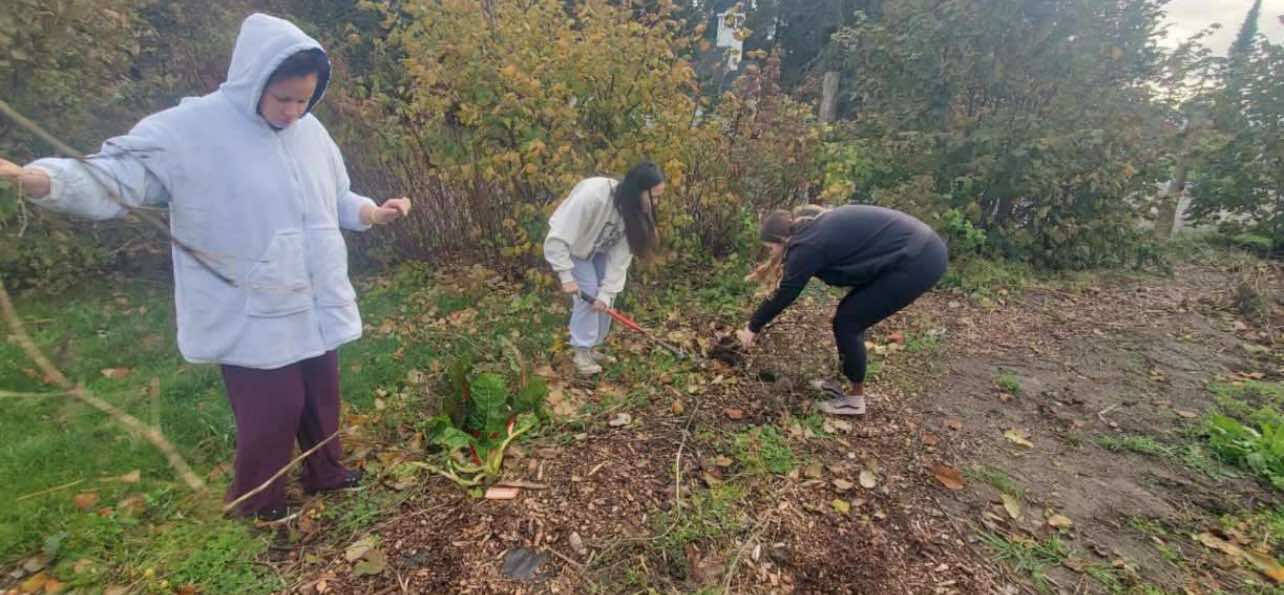 Students use compost that they facilitated from their worm bin to help in the school’s garden area.