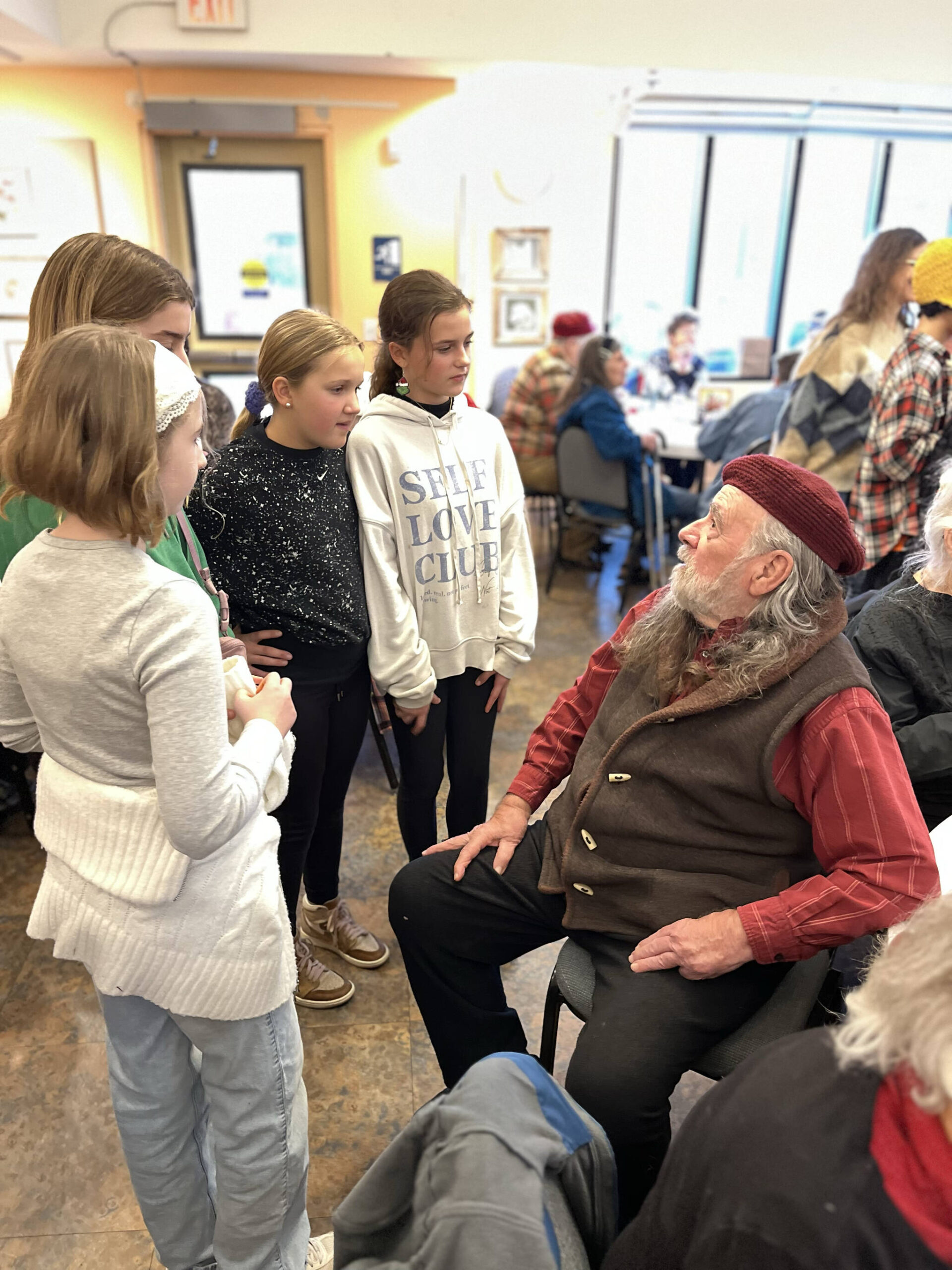 Megan Greene photo.
Left to right: Rose Douglas, Frankie Antonia, Marta Westcott and Eliza Noneman chatting with Ezekiel Barr at the senior center.