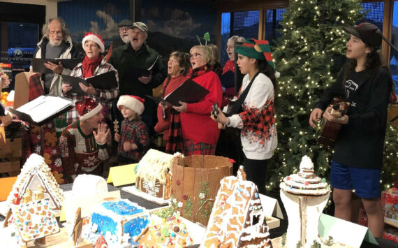 'Tis the season! Orcas Choral Society members and Orcas Christian School students carol at Island Market Dec. 16, led by Christian School teacher Andy Rivera.