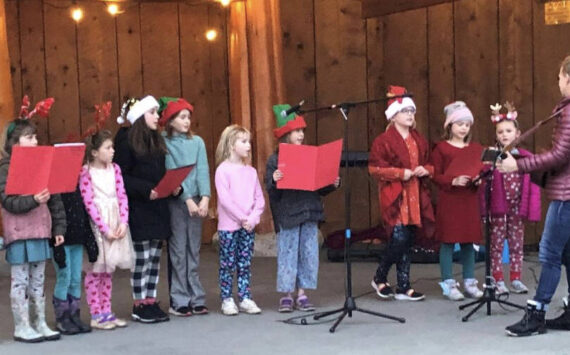 Mary Wachter leads the Kids’ Chorus at the tree lighting on the Eastsound Village Green, Dec. 6.