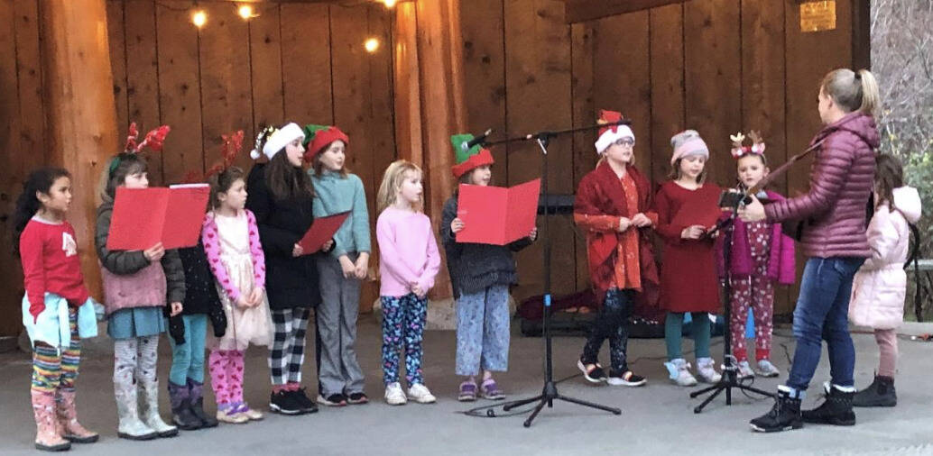 Mary Wachter leads the Kids’ Chorus at the tree lighting on the Eastsound Village Green, Dec. 6.